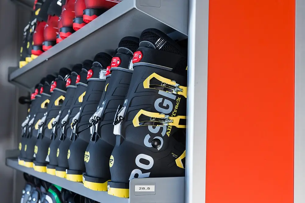 Beheizte Schuhtrockner-Fächer mit Rossignol-Skischuhen und roter Fachtür (Skidepot)