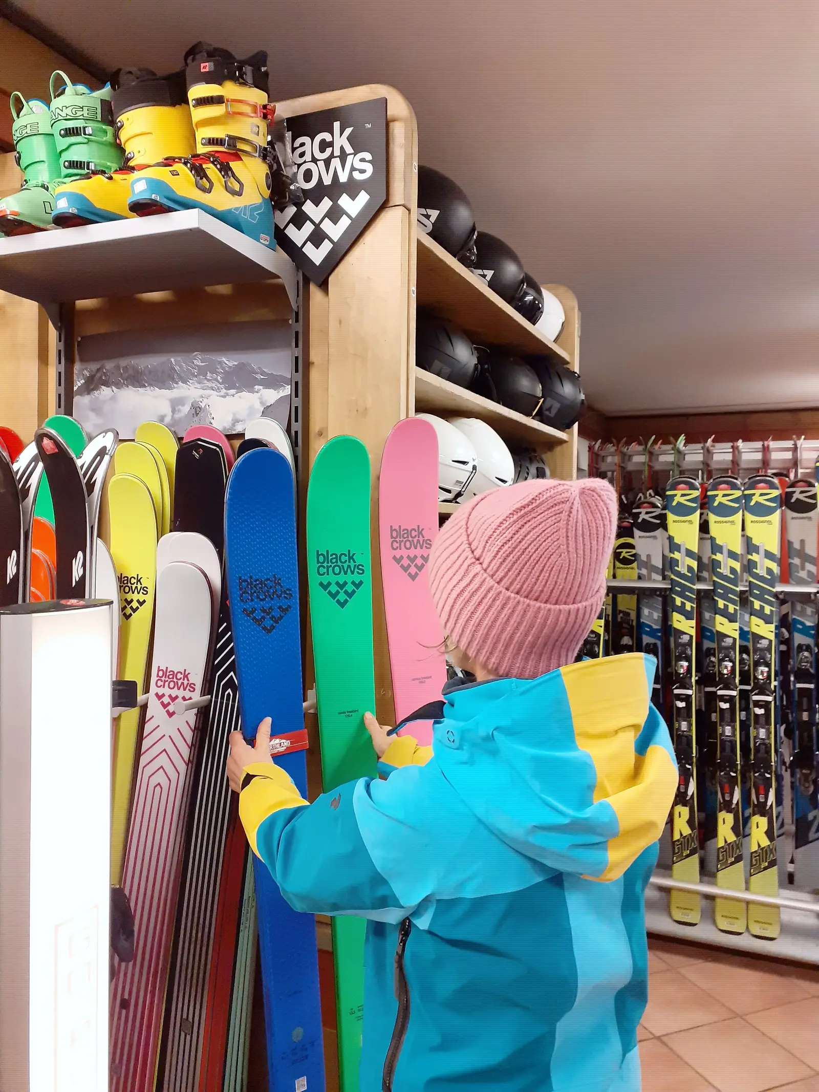Child looking at the ski wall in the shop