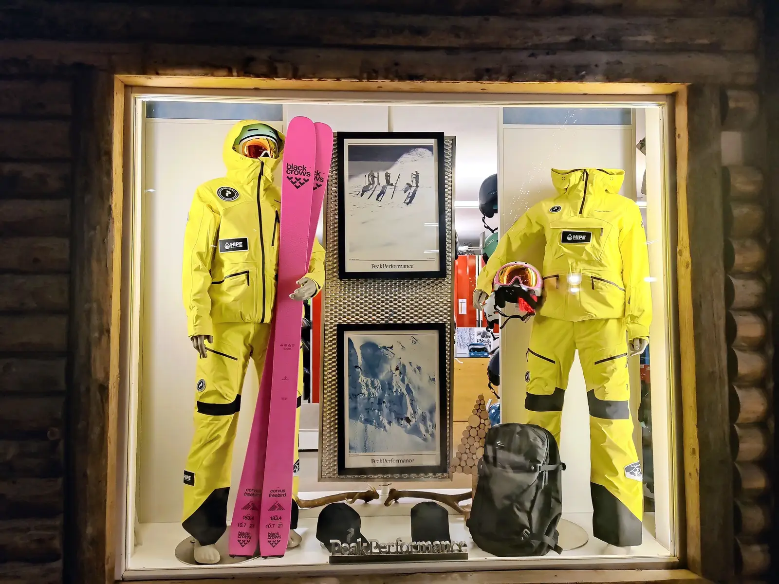 Shop window with yellow ski suits and pink skis